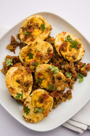 Masala Egg Tawa Fry or ande ki sabzi, served in a plate. selective focus