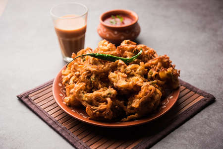 Fried onion pakora or Pyaj Pakoda also known as Crispy Kanda bhaji /Bhajji / bajji, favourite Indian Tea-Time snack during the rainy season. served with tomato ketchupの写真素材