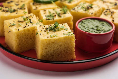Gujarati Khaman Dhokla made using Chana Dal, served with Green chutney, selective focus