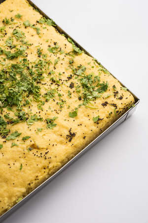Gujarati Khaman Dhokla made using Chana Dal, served with Green chutney, selective focus