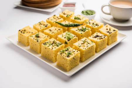 Gujarati Khaman Dhokla made using Chana Dal, served with Green chutney, selective focus