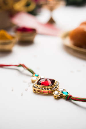 Raksha Bandhan / Rakshabandhan Rakhi with Haldi Kumkum rice, sweet Mithai, Gift Box, selective focusの写真素材