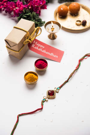 Raksha Bandhan / Rakshabandhan Rakhi with Haldi Kumkum rice, sweet Mithai, Gift Box, selective focusの写真素材