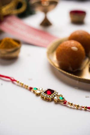 Raksha Bandhan / Rakshabandhan Rakhi with Haldi Kumkum rice, sweet Mithai, Gift Box, selective focusの写真素材