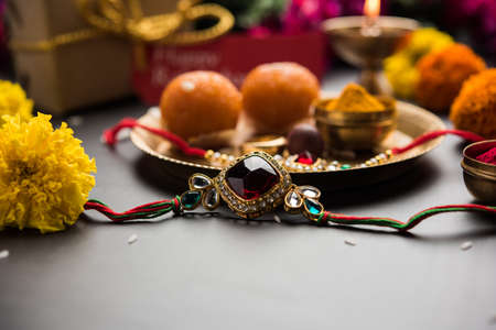 Raksha Bandhan / Rakshabandhan Rakhi with Haldi Kumkum rice, sweet Mithai, Gift Box, selective focusの写真素材