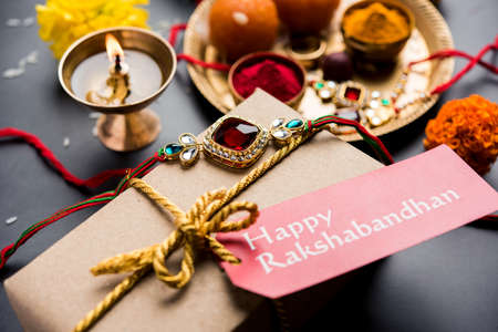 Raksha Bandhan / Rakshabandhan Rakhi with Haldi Kumkum rice, sweet Mithai, Gift Box, selective focusの写真素材