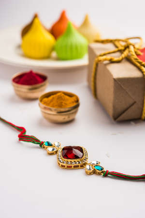 Raksha Bandhan / Rakshabandhan Rakhi with Haldi Kumkum rice, sweet Mithai, Gift Box, selective focusの写真素材