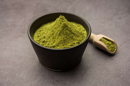 Herbal henna or Mehandi powder in a bowl forming heap, Used for Tattoo or Hair Dye in India