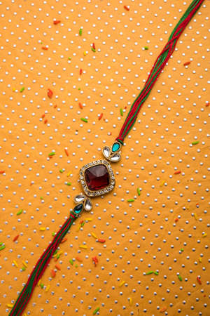 Designer Rakhi / Raakhi or Wristband for Indian Festival Raksha Bandhan, isolated over decorative...