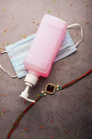 concept of Raksha Bandhan or Rakhi Festival in Corona Virus or Covid-19 Pandemic showing Rakhi /...