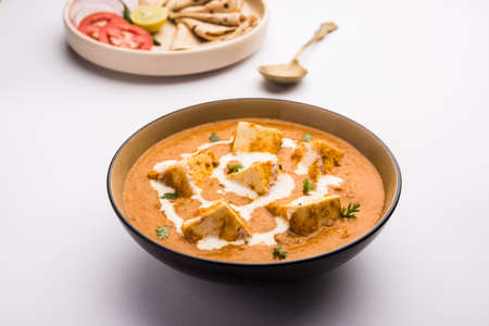 Paneer Butter Masala or Cheese Cottage Curry, popular Indian Lunch/Dinner menu Â served in a ceramic bowl, selective focusの写真素材
