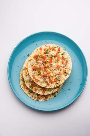 Masala Papad orÂ papadumÂ is a delicious Indian snack made using roasted or fried papad topped with a tangy and spicy onion tomato mixの写真素材