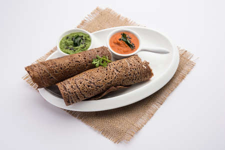 Finger Millet orÂ Ragi DosaÂ is a healthy Indian breakfast served with chutney, in roll, flat or cone shapeの写真素材