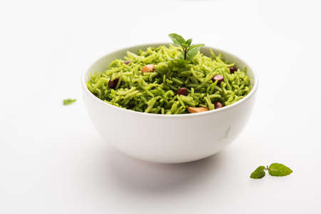 Mint Rice - Basmati rice cooked with fresh pudina leaves and garnished with Peanuts and Cashew nuts or kajuの写真素材