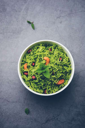 Mint Rice - Basmati rice cooked with fresh pudina leaves and garnished with Peanuts and Cashew nuts or kajuの写真素材