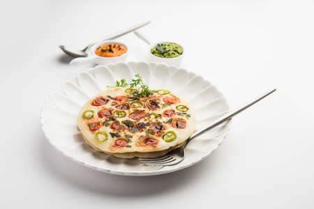 Uthappam orÂ uttapamÂ is a type of dosa from South India which is thicker, with tomato, onion and chilli toppingsの写真素材