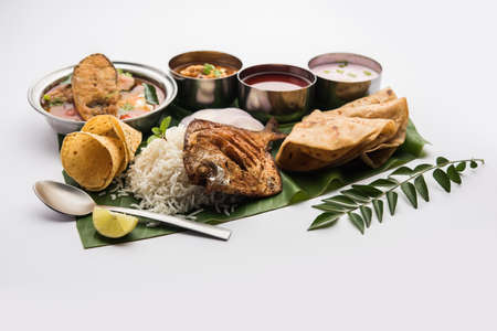 Indian Fish Platter or thali - Popular sea food, Non vegetarian meal from Mumbai, Konkan, Maharashtra, Goa, Bengal, Kerala served in a steel plate or over banana leafの写真素材