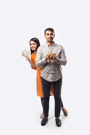 Indian couple holding gold jewelry, ornaments - Asset or Gold Loan conceptの写真素材