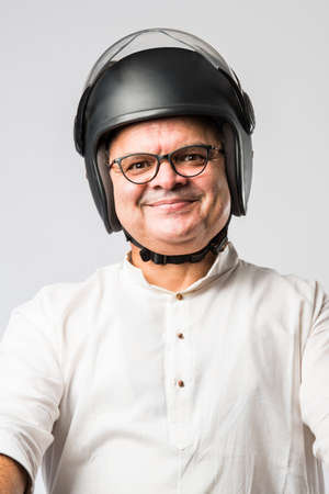 Long descriptionIndian old man wears helmet for safety, senior asian man with head protection gear