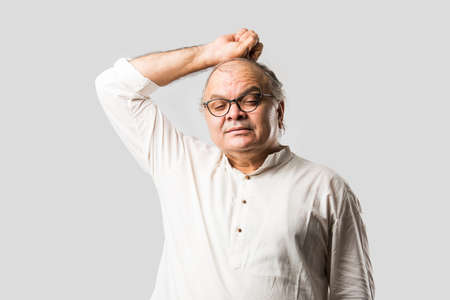 Indian asian old man having pain or ache in different body parts, sad expressionsの写真素材