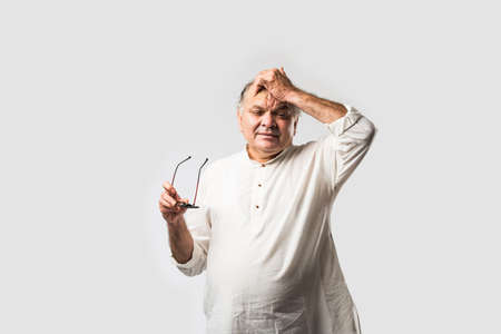 Indian asian old man having pain or ache in different body parts, sad expressionsの写真素材
