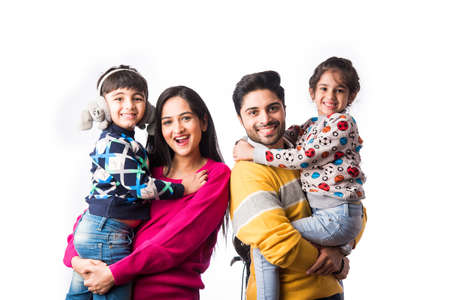 Asian Indian young family wears sweater or warm woolen or woollen winter cloths, standing isolated...