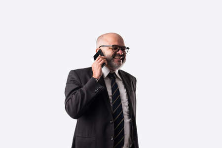 Portrait of old Indian asian businessman using smartphone for messaging, calling or showing or...