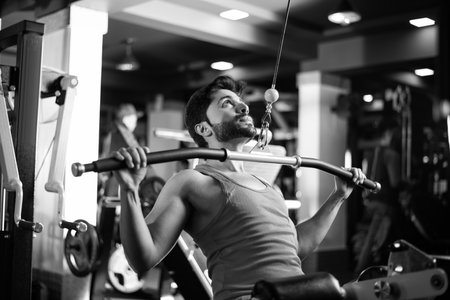 Indian asian handsome man working out or exercising in the gym - Health and fitness concept