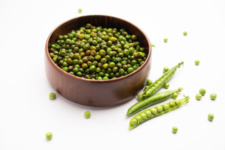 green spicy peas fried or roasted namkeen, dry snacks or chakna consumed with cocktail drinks in Indiaの写真素材