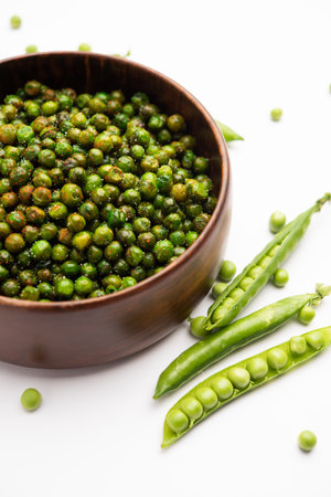 green spicy peas fried or roasted namkeen, dry snacks or chakna consumed with cocktail drinks in Indiaの写真素材