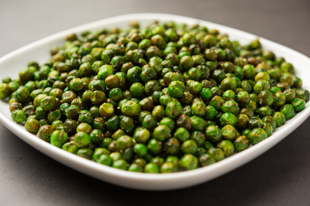 green spicy peas fried or roasted namkeen, dry snacks or chakna consumed with cocktail drinks in Indiaの写真素材