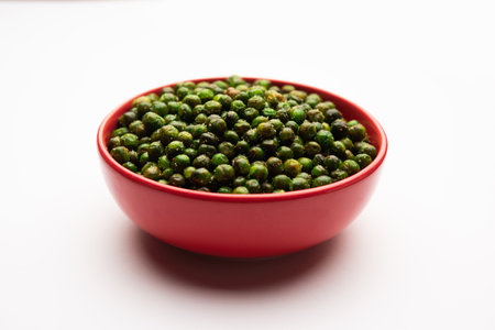 green spicy peas fried or roasted namkeen, dry snacks or chakna consumed with cocktail drinks in Indiaの写真素材