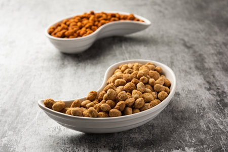 Indian besan coated crunchy and spicy masala peanuts or mungfali served in a bowl or plate