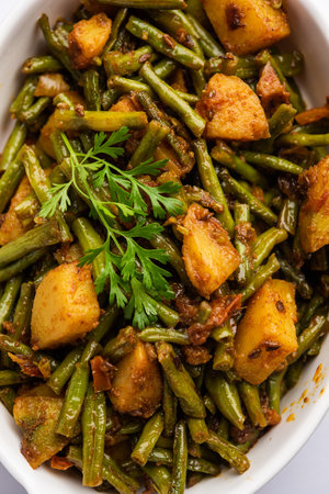 Indian style Chawli Aloo subjiÂ or sabzi, long bean and potato dry fry, served in a bowl,...
