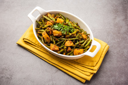 Indian style Chawli Aloo subjiÂ or sabzi, long bean and potato dry fry, served in a bowl,...
