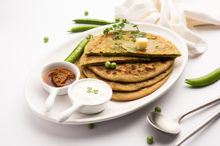 Green Peas or matar ka parathaÂ is a Punjabi dish which is an Indian unleavened flatbread made with whole wheat flour,Â greenÂ peas. Served with ketchup and curdの写真素材