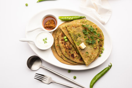 Green Peas or matar ka parathaÂ is a Punjabi dish which is an Indian unleavened flatbread made with whole wheat flour,Â greenÂ peas. Served with ketchup and curdの写真素材