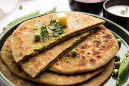 Green Peas or matar ka parathaÂ is a Punjabi dish which is an Indian unleavened flatbread made with whole wheat flour,Â greenÂ peas. Served with ketchup and curdの写真素材