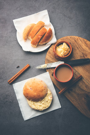 bun-maskaÂ Tea or bun Maska chaiÂ combo features a slightly sweet bun studded with raisins that is cut into half and laden with wholesome butter, Mumbai foodの写真素材