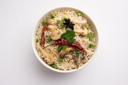 TastyÂ Mushroom or Mashroom Rice or PulavÂ or PilafÂ or Pulao or Biryani served in a bowl or plate, selective focusの写真素材
