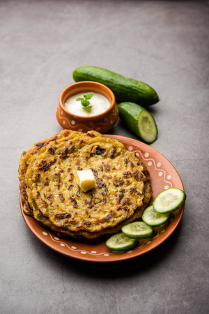 MaharashtrianÂ KakdiÂ Thalipeeth or Punjabi cucumber paratha, made from fresh gratedÂ kheeraÂ for breakfast and serve it along with yogurtの写真素材