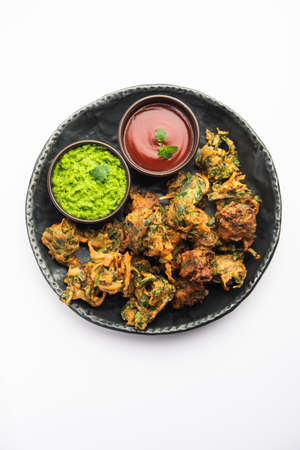 Homemade tasty Palak pakoda or pakora known as Spinach Firtters, served with ketchup. Favourite...
