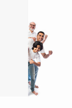 Multigenerational Indian asian family with white board, pointing or presenting empty white placard