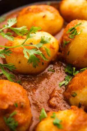 Tasty Dum Aloo or whole potatoes spicy curry is a popular main course recipe from Indiaの写真素材