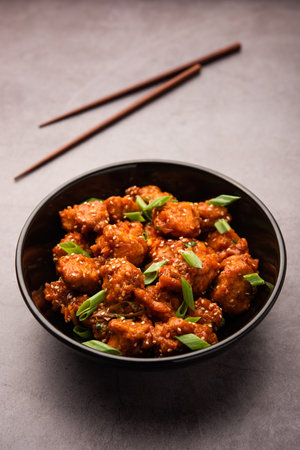Chilli ChickenÂ is a sweet, spicy and crispy appetizer, most popular in Indo-chinese cuisine, served on a plate. selective focusの写真素材