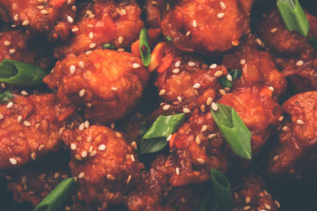 Chilli ChickenÂ is a sweet, spicy and crispy appetizer, most popular in Indo-chinese cuisine, served on a plate. selective focusの写真素材