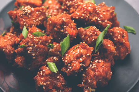 Chilli ChickenÂ is a sweet, spicy and crispy appetizer, most popular in Indo-chinese cuisine, served on a plate. selective focusの写真素材