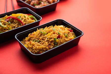 Group of home delivered Indo Chinese food in plastic packages, containersÂ or boxes containingÂ schezwan noodles, fried rice, chilli chicken, manchurian and soup. Online food ordering concept in Indiaの写真素材