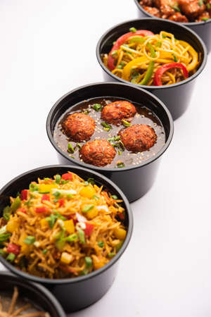 Group of home delivered Indo Chinese food in plastic packages, containersÂ or boxes...