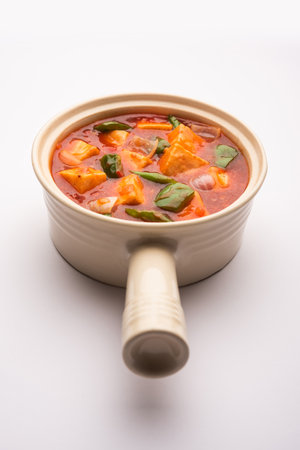 Chilli paneer or Spicy cottage cheese, served in bowl with capsicum and onion, favourite indian starter menu, selective focusの写真素材